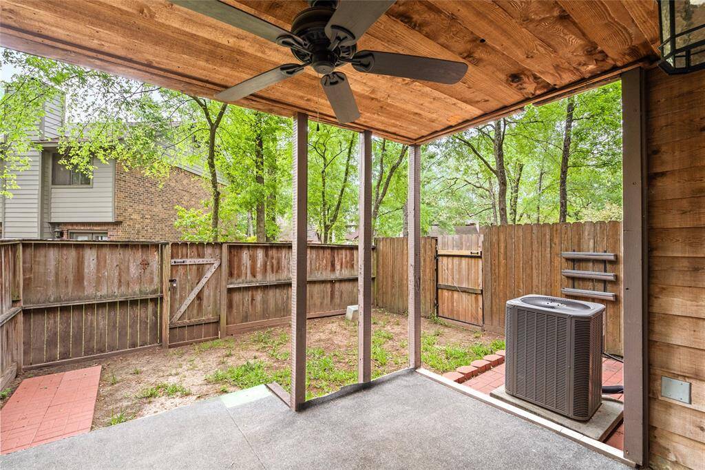Your back yard has a covered patio with a ceiling fan with a mixture of grass and paved areas and privacy fence with a gate to the common area.