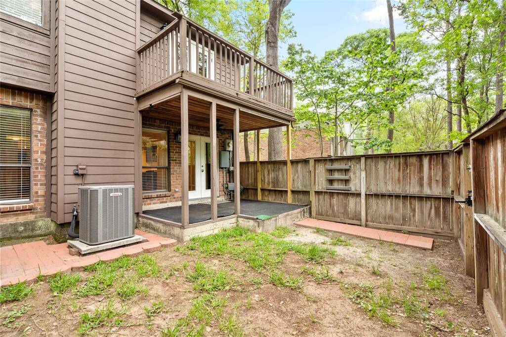 Another view of your backyard surrounded by trees providing a natural and secluded setting.