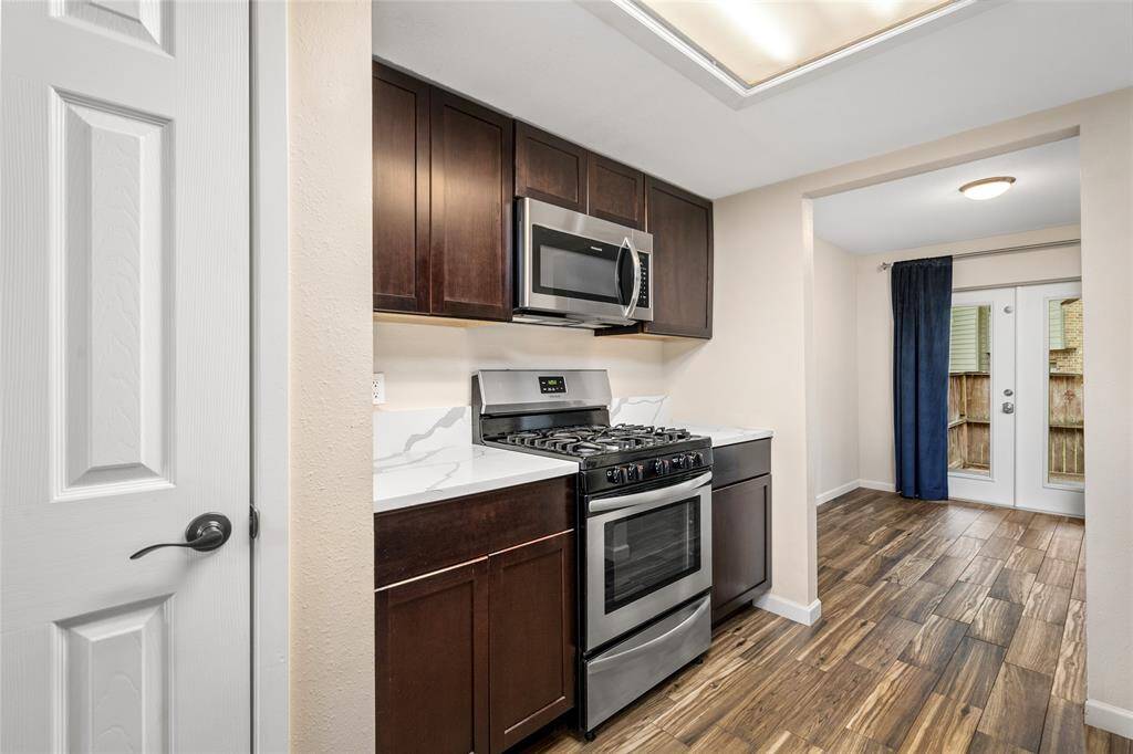 The five burner stainless steel range and overhead microwave will surely make cooking a delight. French doors leading to the outdoor area provide natural light and easy access to the backyard.