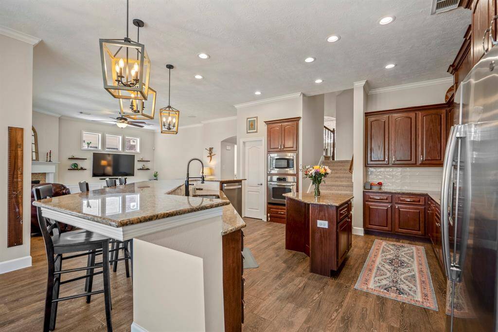A convenient staircase located just off the kitchen provides easy access to the second level, offering a seamless flow throughout the home.