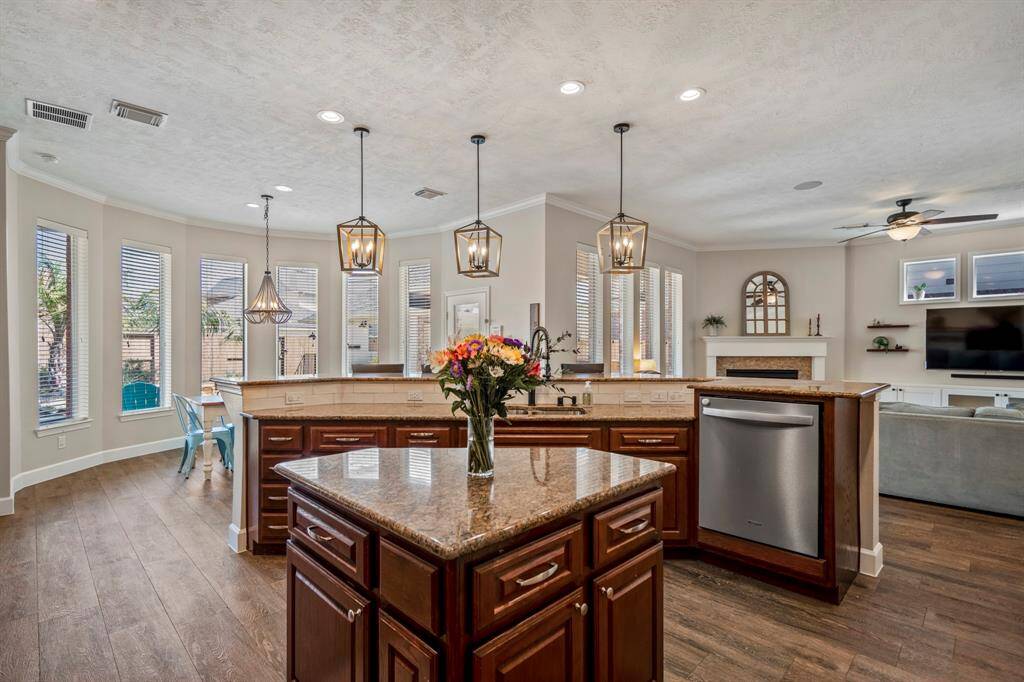 The breakfast nook is surrounded by picturesque windows, creating a sunlit space to enjoy morning coffee with a view of the backyard retreat.