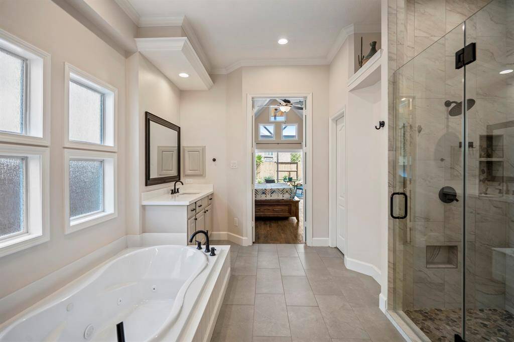 The ensuite seamlessly connects to the primary suite, offering convenience, comfort, and direct access to the backyard oasis. A true retreat within your home!