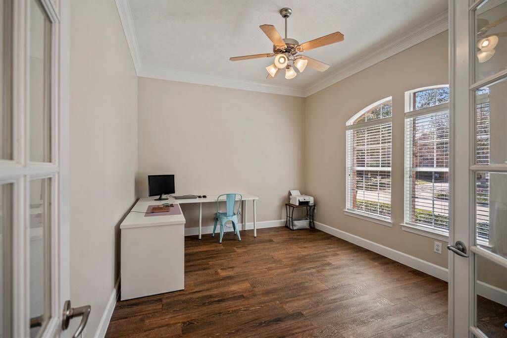 Off the entry, French doors lead to a bright and airy study—perfect for working from home—with oversized windows that flood the space with natural light.