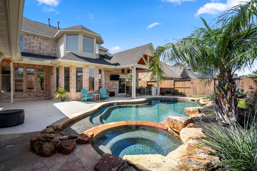 Day-to-night backyard elegance—bask in the Texas sun or enjoy the serene glow of the pool under twilight skies, perfect for entertaining or unwinding.