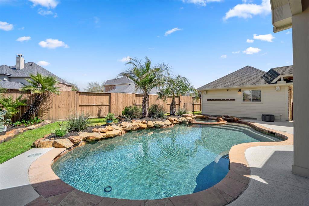 Luxury poolside escape—custom lagoon-style pool surrounded by tropical landscaping, offering the ultimate in relaxation.