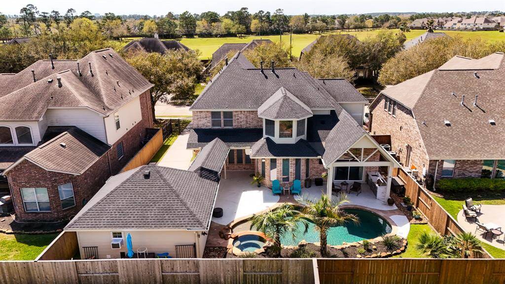 Outdoor Living at Its Finest! The fully equipped outdoor kitchen boasts a built-in stainless steel grill, sink, and ample counter space, making al fresco dining effortless. The covered patio with recessed lighting and a ceiling fan extends your living space year-round.