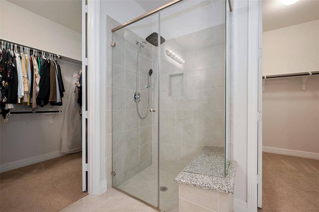 Positioned between two full entry closets, the shower area feels like a private enclave, offering both functionality and a sense of retreat.