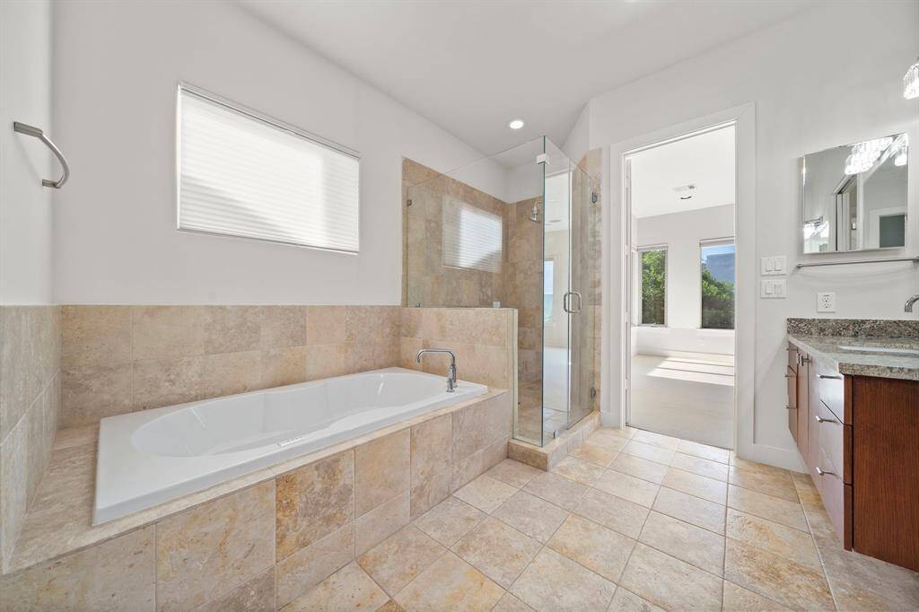 Primary Bath. All baths have matching granite countertops and sleak American Standard Fixtures