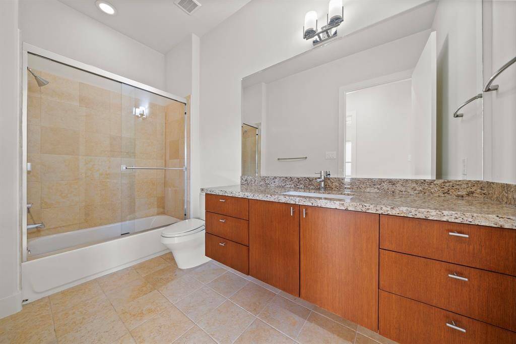 2nd Bedroom: Full Bath. Hardwood cabinetry and  hardware are matched throughout the home.