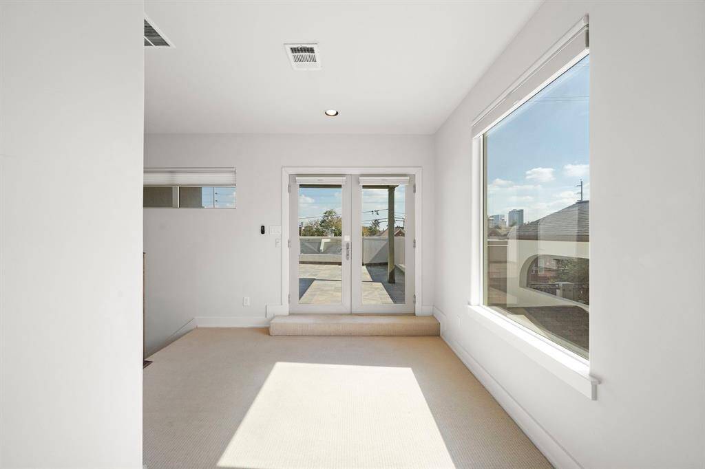 Top-Level Retreat: Luxurious wool-carpeted landing leads to an exclusive rooftop patio and a versatile third bedroom that can serve as a game room, guest suite, or cozy lounge.