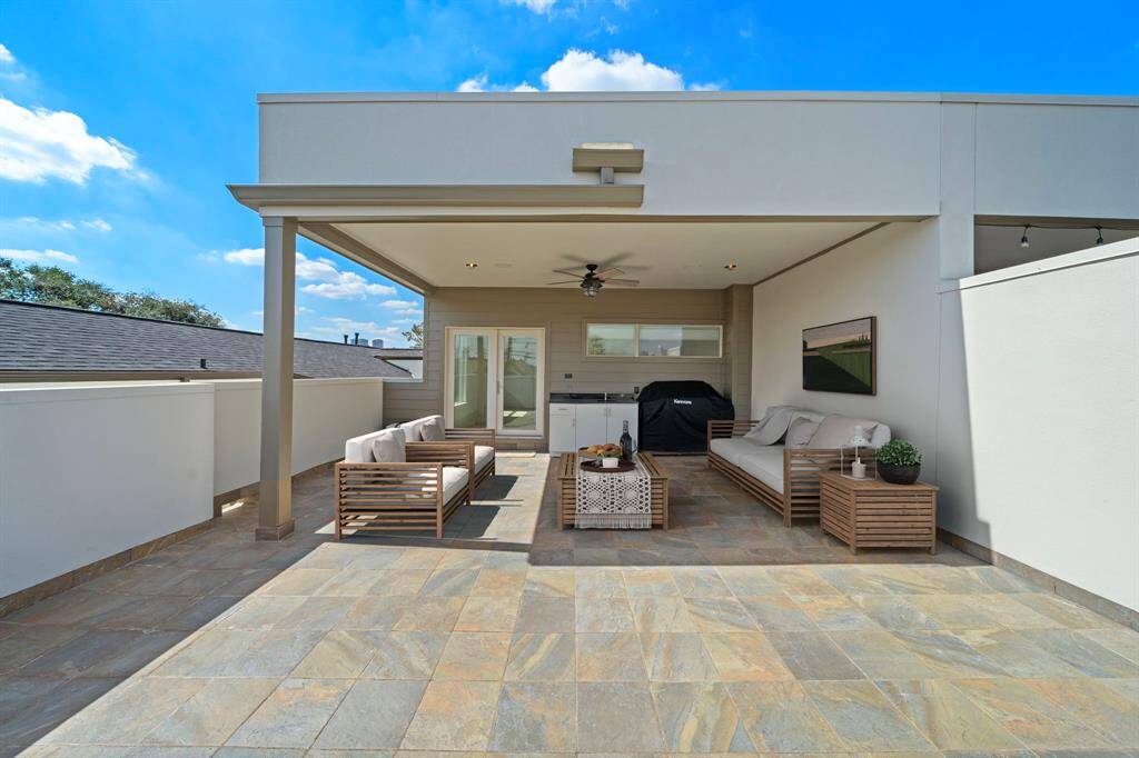 Rooftop patio with outdoor kitchen and clear views of Downtown Houston
