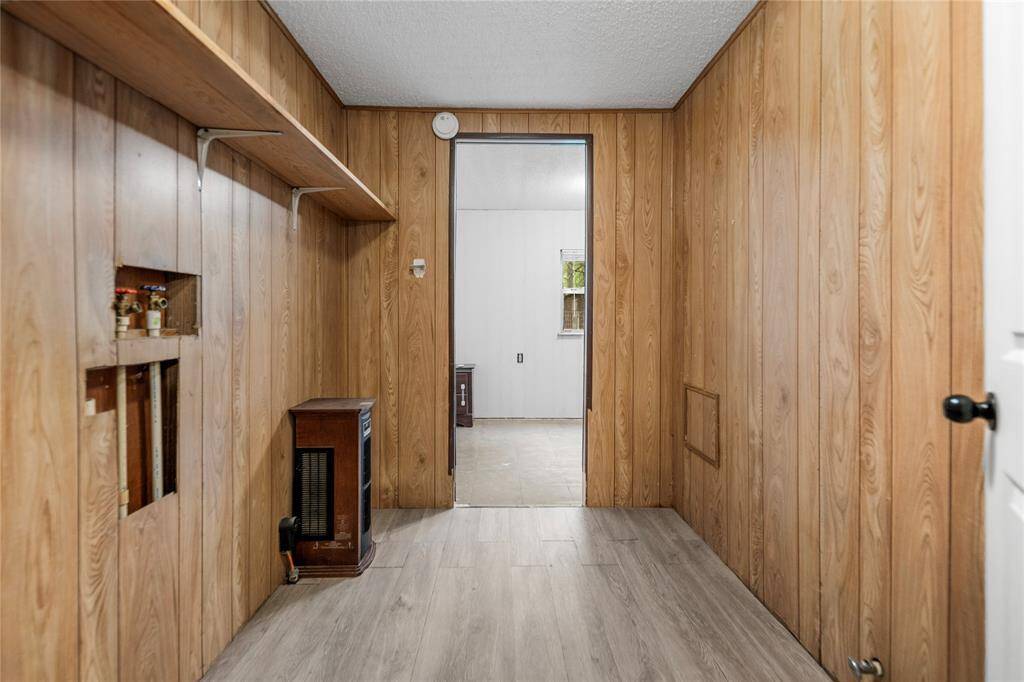 The laundry area provides utility space with room for storage and washer/dryer setup. Plenty of wall space and access to plumbing make it a great candidate for a sleek update.