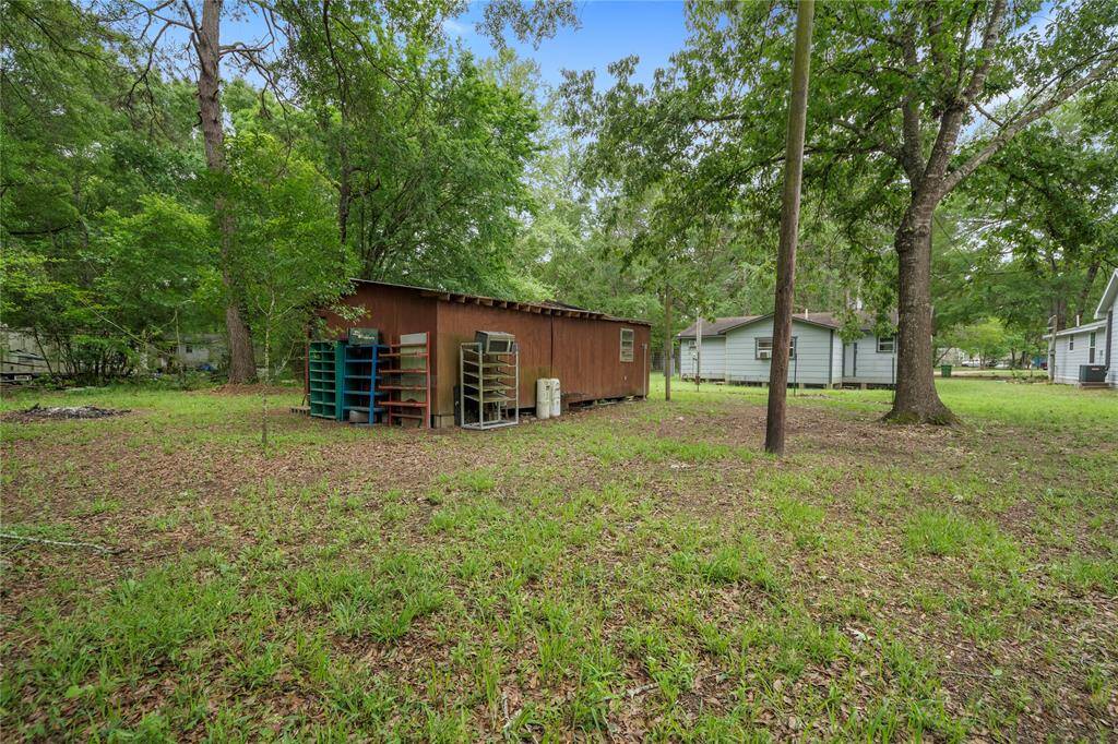 Enjoy the spacious, tree-shaded backyard with plenty of room for expansion, entertaining, or a serene outdoor retreat. The surrounding mature trees add both privacy and charm.