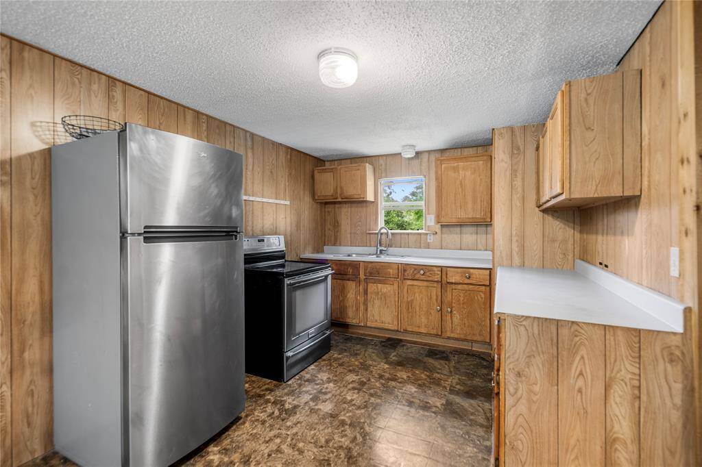 The kitchen features solid cabinetry and a practical layout with plenty of prep space. Whether you're upgrading for personal use or flipping for resale, this room is full of potential to become a standout.