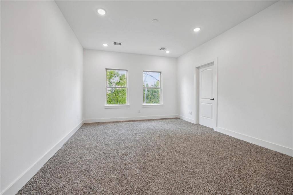 The spacious bedroom has 2 large windows for natural lighting and plush carpet. It also features an impressive en-suite bathroom.