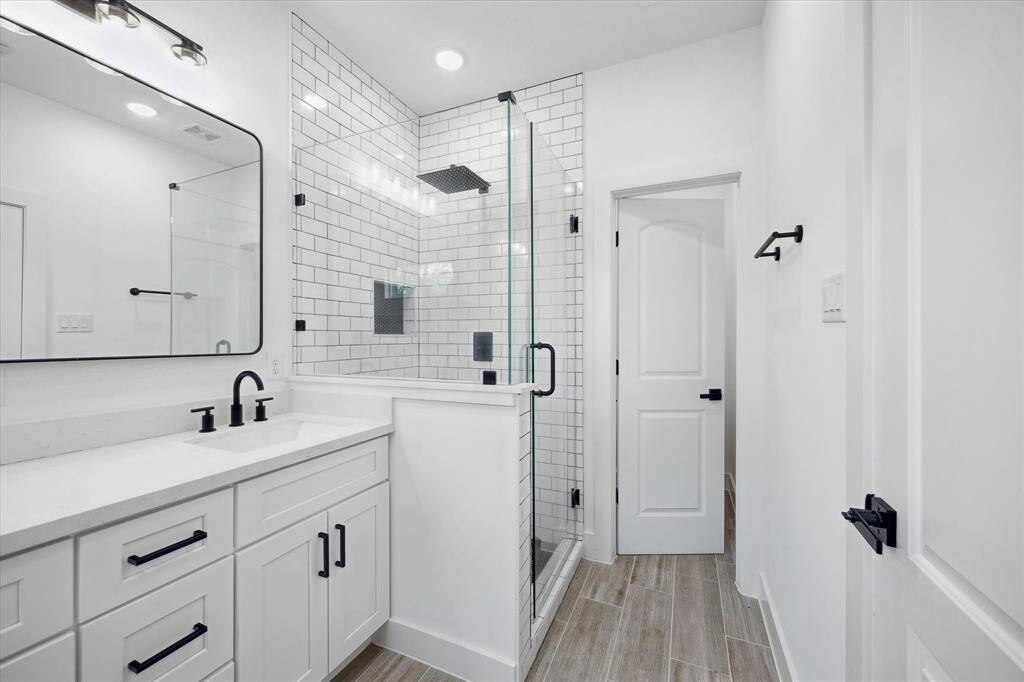 The primary suite also features a frameless subway tiled shower.