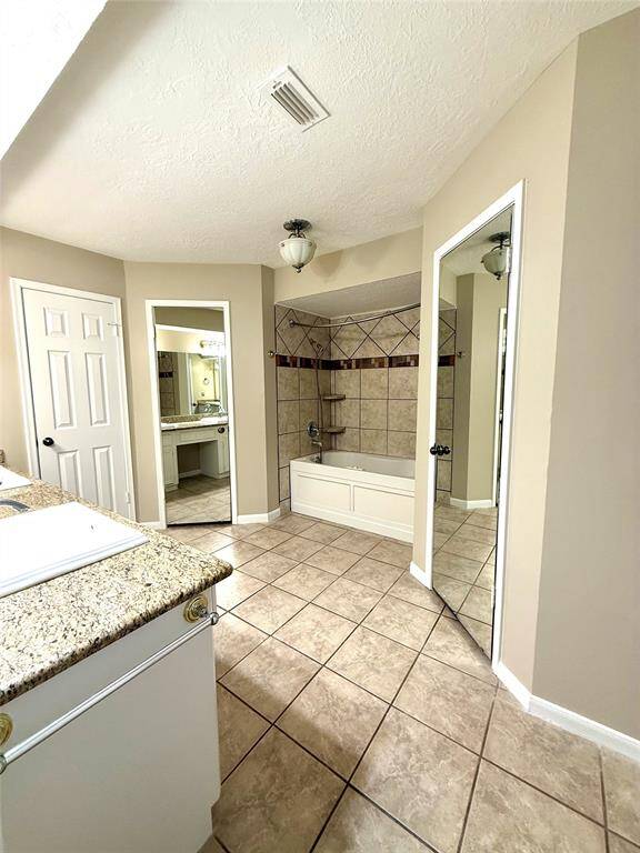Primary Bathroom with His and Her Matching Closets