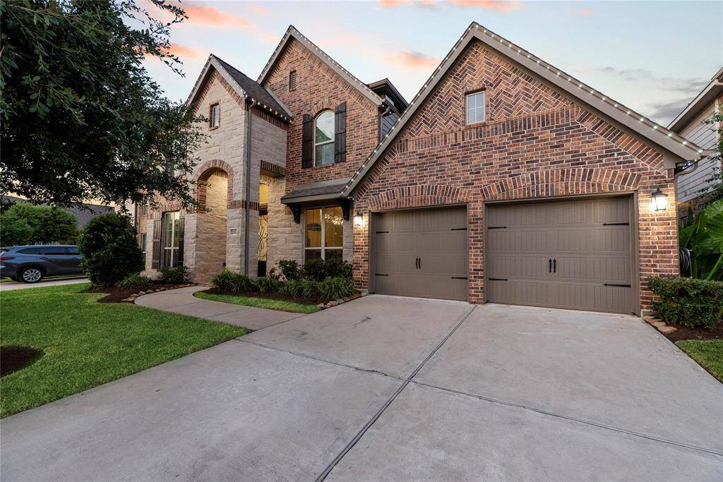 Welcome home to this beautiful two-story home features a charming brick and stone exterior with a 3-car Tandem garage. The well-maintained front yard and inviting entrance create a warm, welcoming atmosphere.