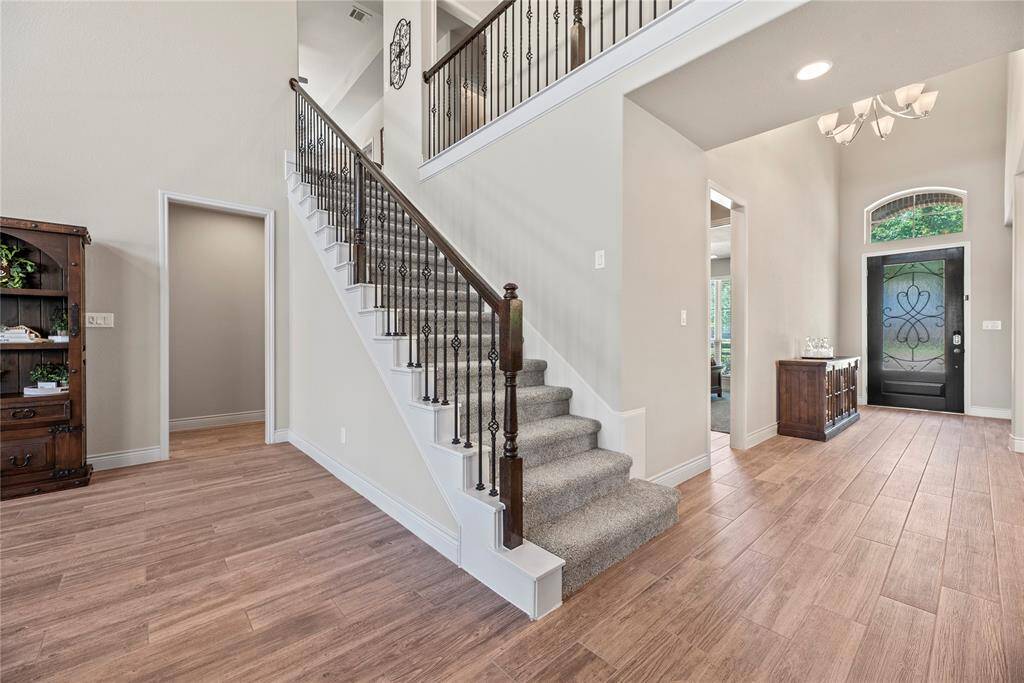This welcoming entryway has an inviting first impression! Notice the beautiful wood look tile floors, brand new carpet and high ceilings.
