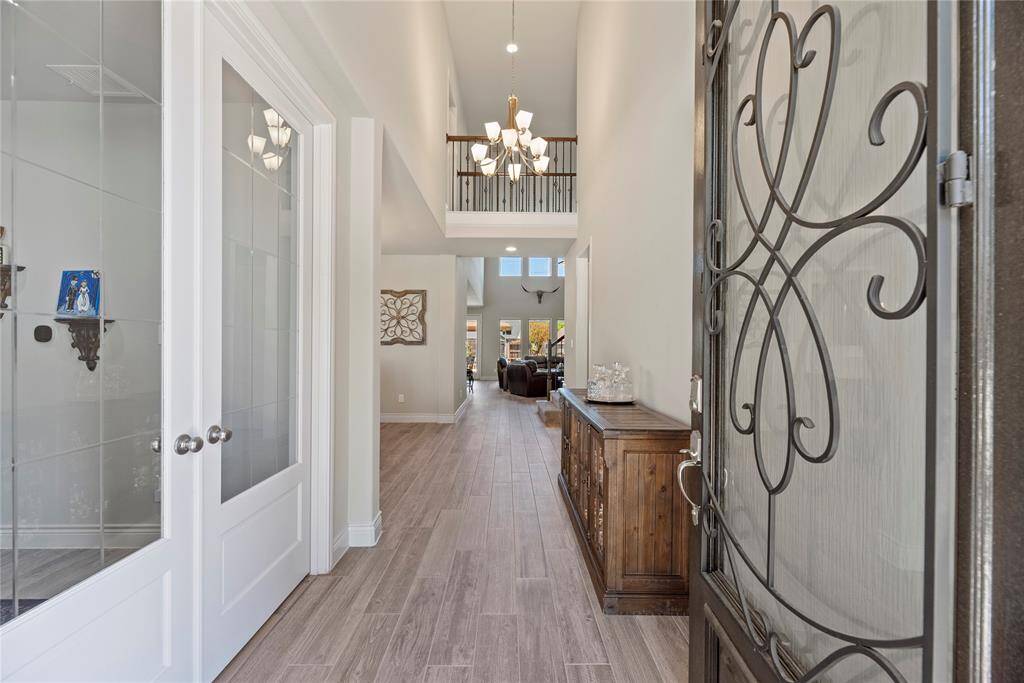 This inviting entryway features a decorative front door, high ceilings. The entry is bright and open! A private study is just to the left of the entrance foyer.