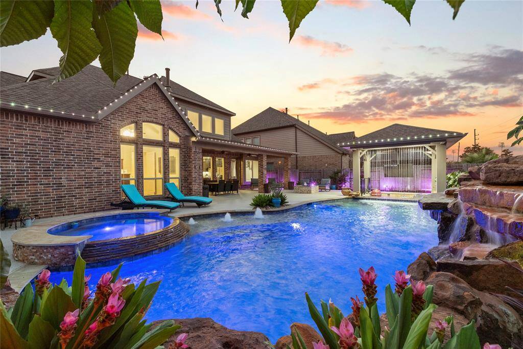 You have the pool, the spa, the swim up pool bar with rain waterfall, rocks waterfalls, sunken kitchen with BBQ and an egg type smoker. This is outdoor living at it's finest!!