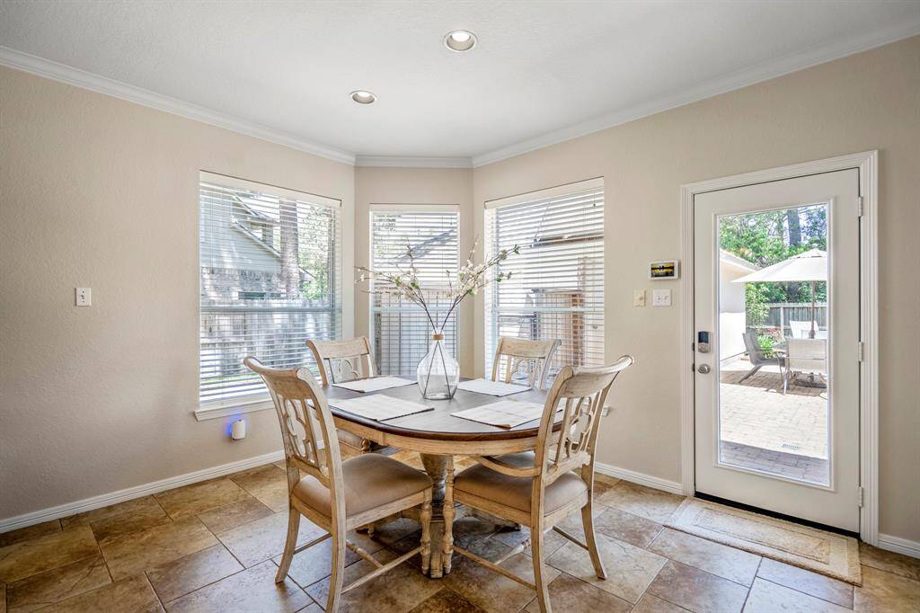 A close-up of the breakfast area, featuring a charming bay window that fills the space with natural light. A patio door provides easy access to the outdoor living area, making this space perfect for casual meals or enjoying the view.