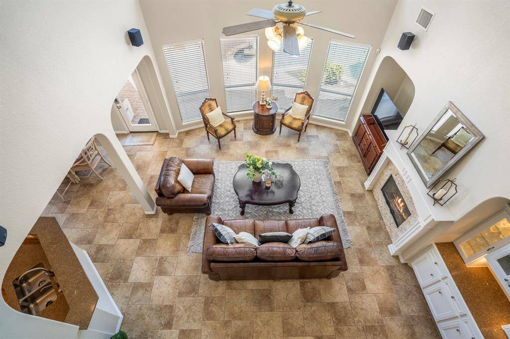 Moving across the upstairs landing, we take in the stunning view of the living room below. The open design allows you to look down into the two-story space, enhancing the home's sense of airiness and connection.