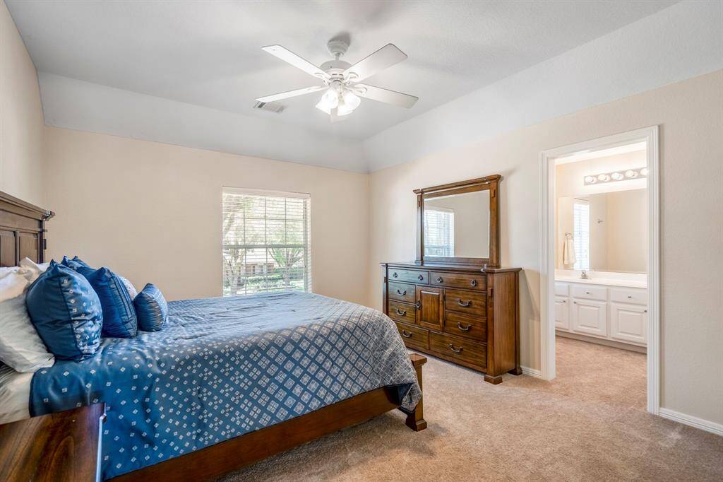 Another spacious upstairs bedroom featuring a large walk-in closet and a window overlooking the front yard. Just beyond, you can see the opening to the vanity area, which leads into the Jack and Jill bathroom connecting to the fourth bedroom.
