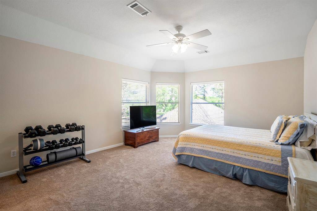 The spacious fourth bedroom features corner bay windows that offer beautiful views of the backyard and pool. With a large walk-in closet, this room provides plenty of space and convenience. It connects to the third bedroom via the Jack and Jill bath.