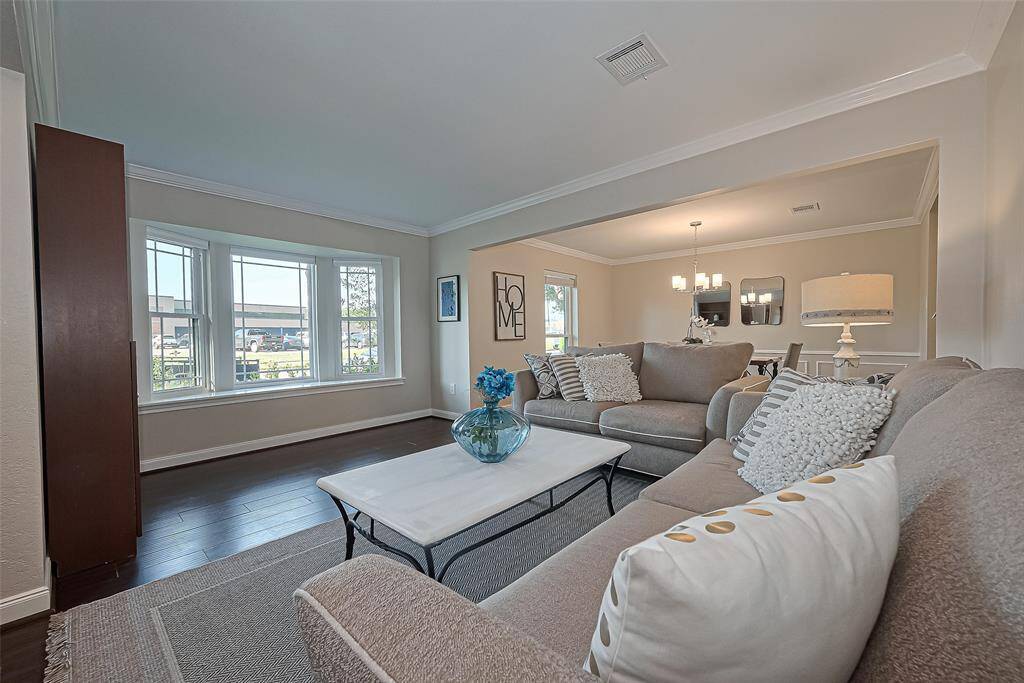 This cozy living room offers an open-concept flow into the dining area, making it perfect for entertaining or enjoying everyday family moments in one connected, inviting space.