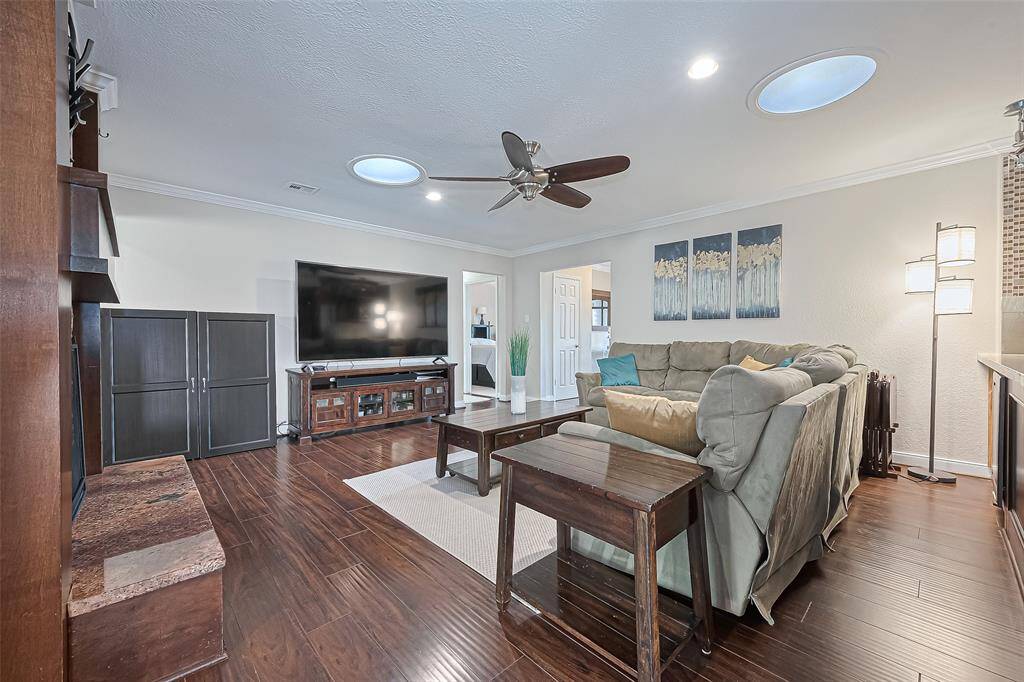 Unwind in the cozy family room, where the soothing ceiling fan and warm ambiance create the perfect space to relax and recharge.