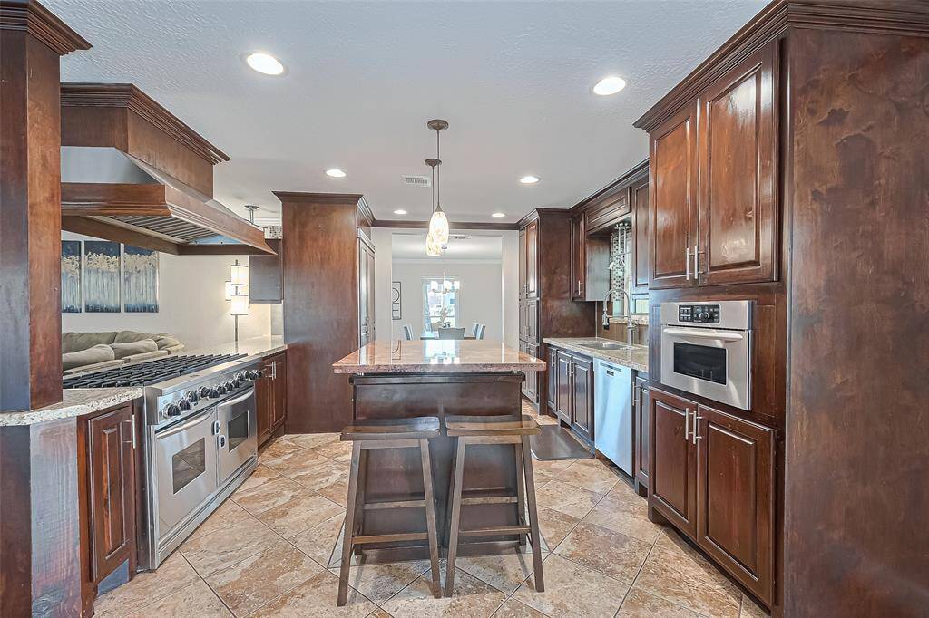 At the heart of this dream kitchen is an impressive 8-burner gas range that transforms everyday cooking into a true culinary experience—whether you're preparing pancakes for a crowd or simmering multiple dishes for a holiday feast, this powerhouse setup is built to keep up with every craving, celebration, and gathering life brings.