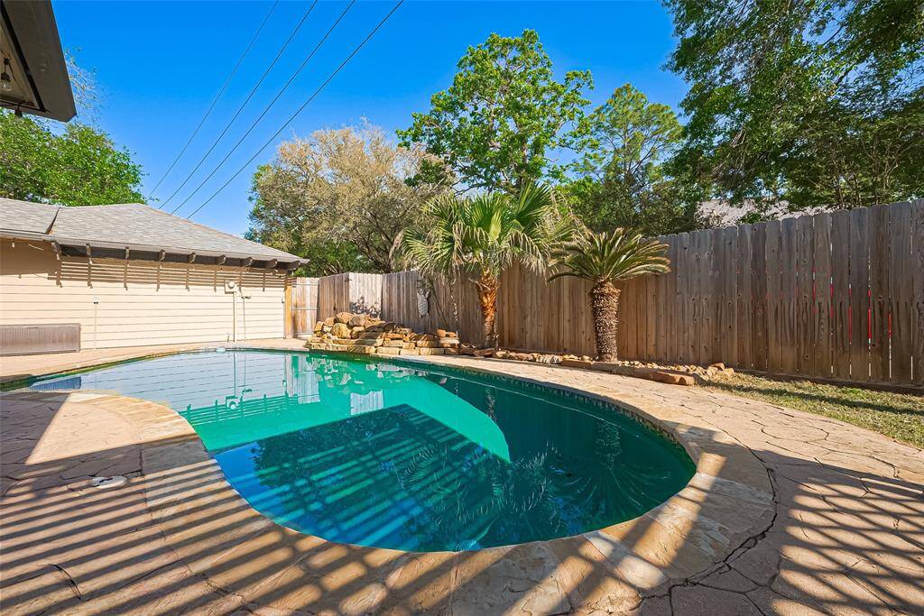 Imagine stepping out each day into your own private oasis, where the crystal-clear pool sparkles beneath the Texas sun and the sound of the waterfall feature instantly melts away the stress of the day. Surrounded by mature trees and tropical touches, this backyard retreat is more than just a place to relax—it’s a lifestyle.
