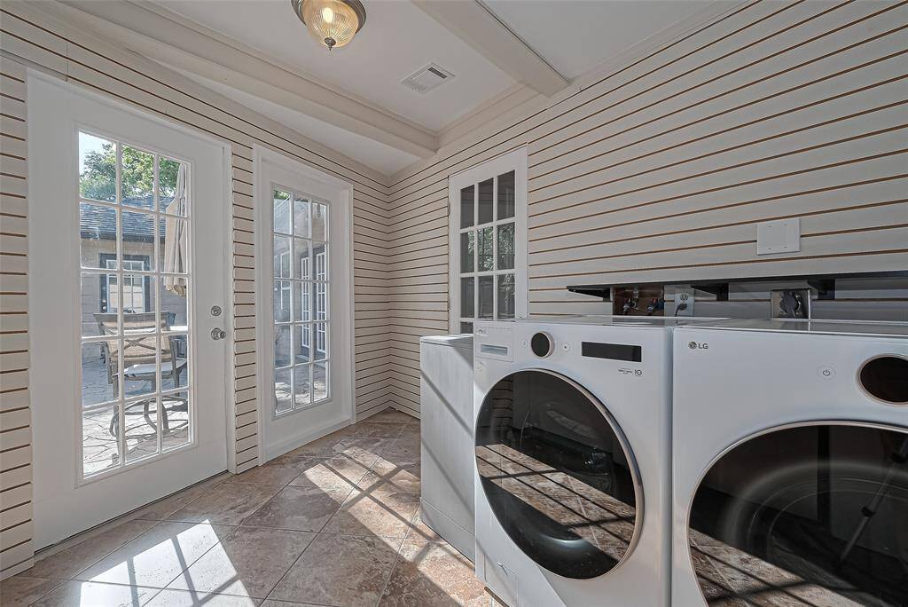 Conveniently located just off the main living space with direct access to the backyard is this bright and breezy laundry room with tile floors, and a ceiling fan—making everyday chores feel just a bit more enjoyable.