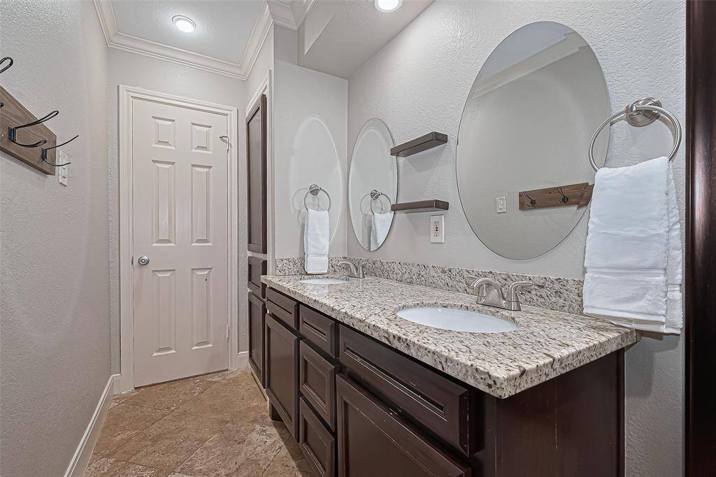 This bathroom’s thoughtful layout offers easy accessibility, with a spacious walkway, double sinks positioned for shared use, and plenty of counter and cabinet space to keep everything within reach—making daily routines smooth and efficient.