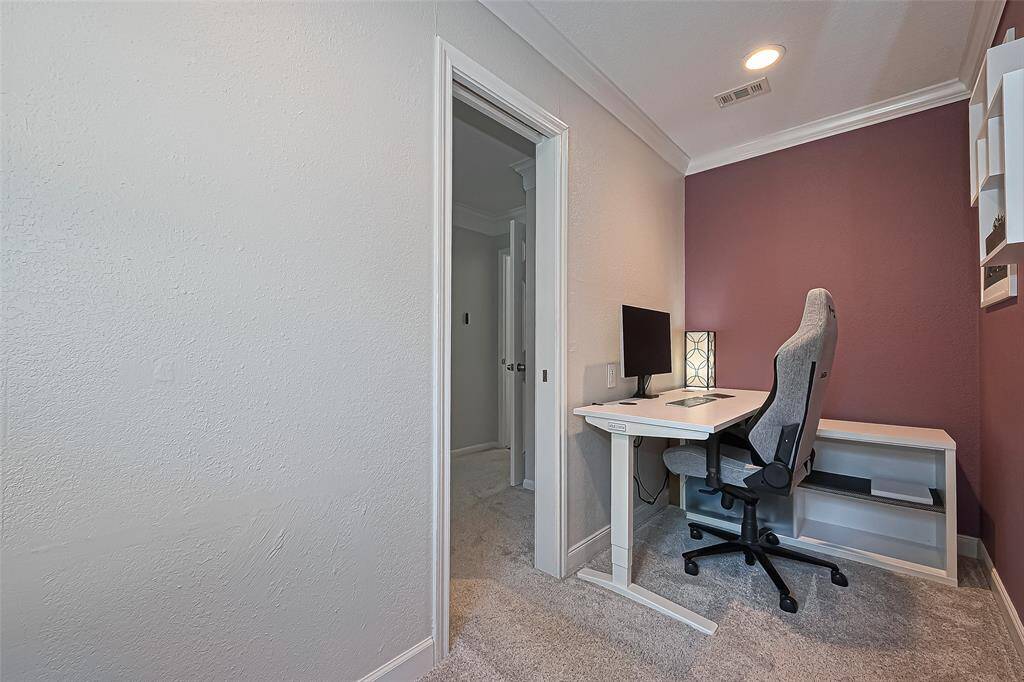Just off the primary retreat, this versatile flex area is perfect for a quiet home office, cozy reading nook, or additional storage to keep everything neatly tucked away.