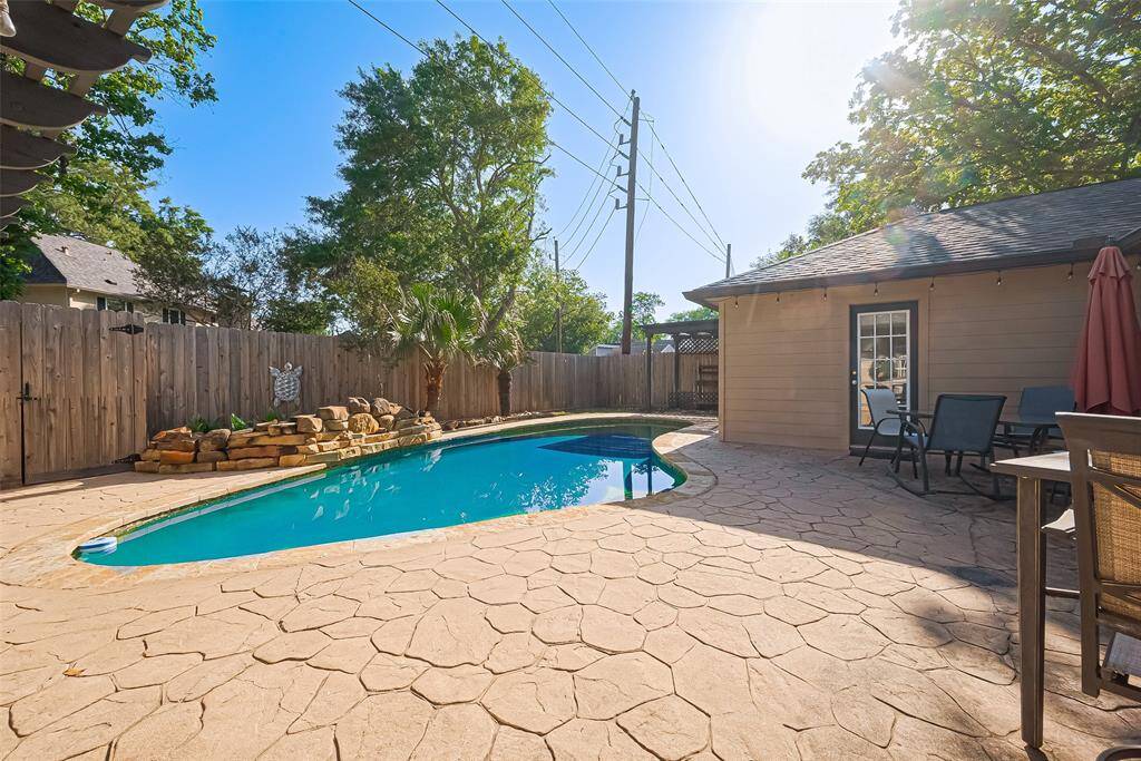 This will be your backyard pool area, the perfect blend of relaxation and charm, complete with a tranquil rock waterfall feature, a spacious patio for entertaining, and plenty of room to soak up the sun or unwind under the stars.