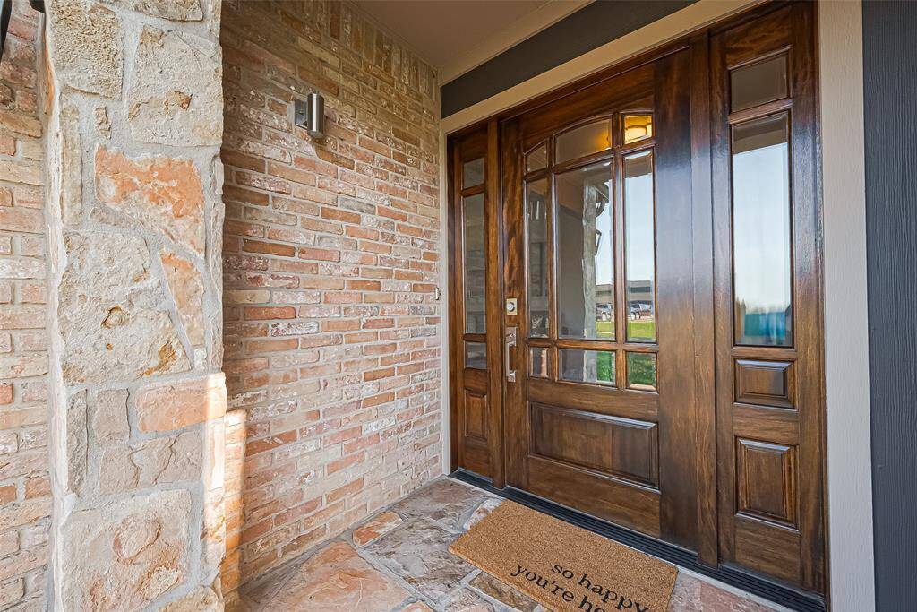 The blend of natural stone and brick right at your doorstep sets a warm, rustic tone before you even step inside.