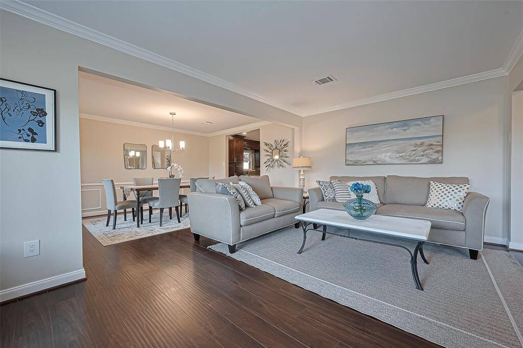The living room flows into the dining area, creating the perfect open-concept space for both everyday comfort and entertaining guests.