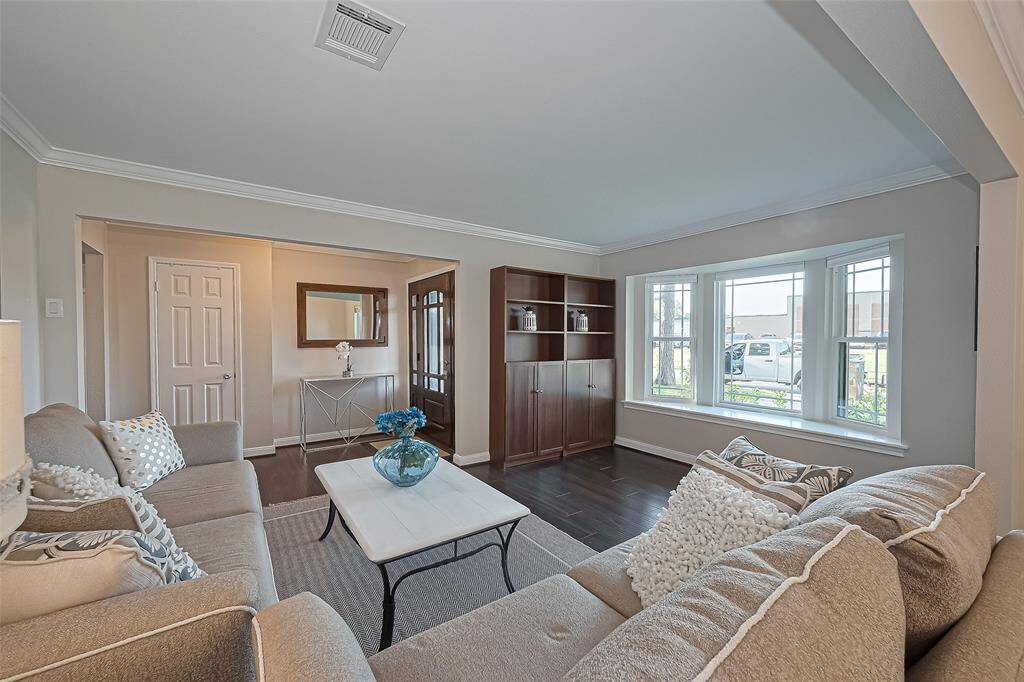 The focal point of this inviting living room is the stunning bay window, flooding the space with natural light and offering a picturesque view of the front landscape.