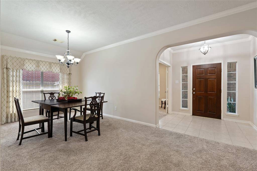 Another view of the spacious formal dining room showcasing the lovely archway from the entry.