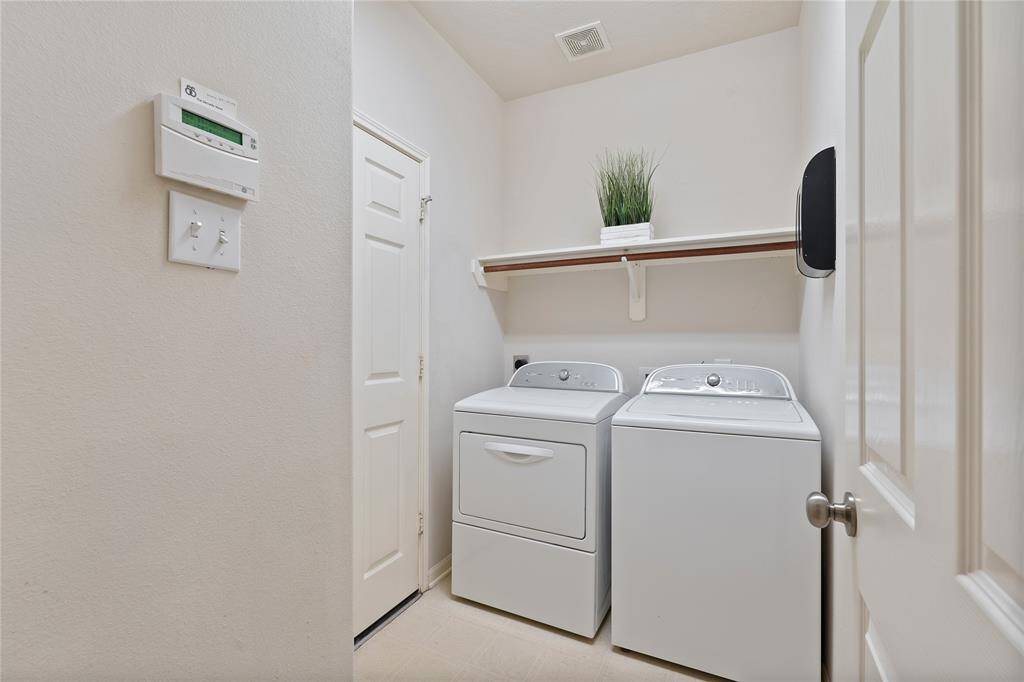 The utility room offers a built-in shelf and private entry to the garage.