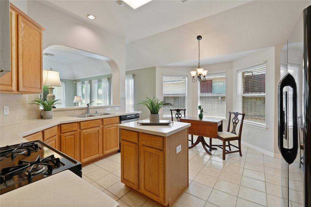 The kitchen opens to the living area and includes a charming breakfast nook surrounded by windows.