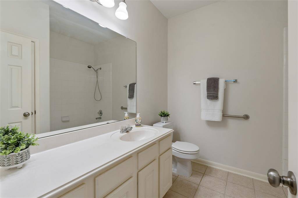 The spacious secondary bathroom offers tons of counter and cabinet space.