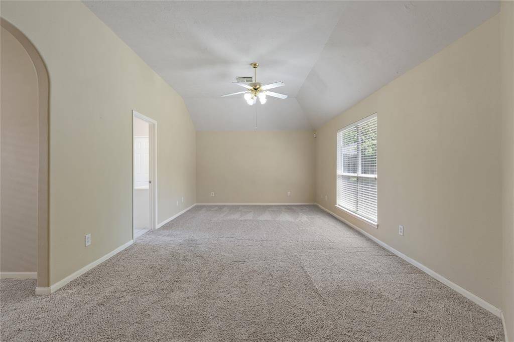 The primary bedroom offers high ceilings and an immense amount of space.