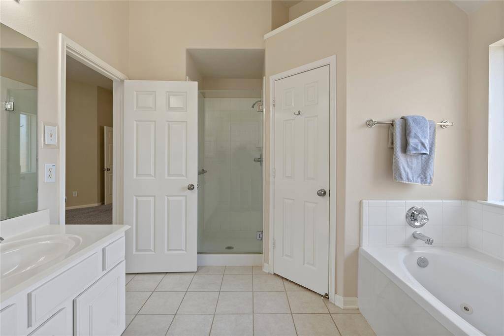 The large walk-in shower offers a spacious, relaxing experience.