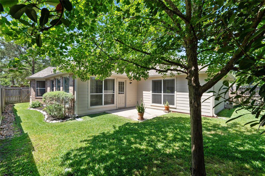 The beautifully landscaped backyard offers a lovely, serene setting.