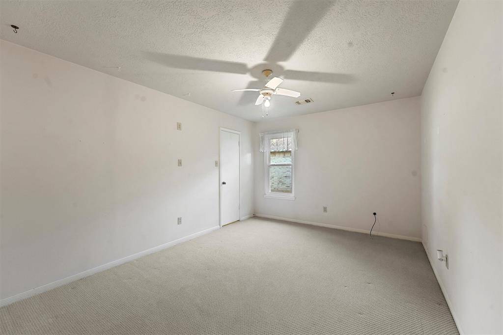 This bedroom is spacious with a large walk-in closet. It features a window for natural light.