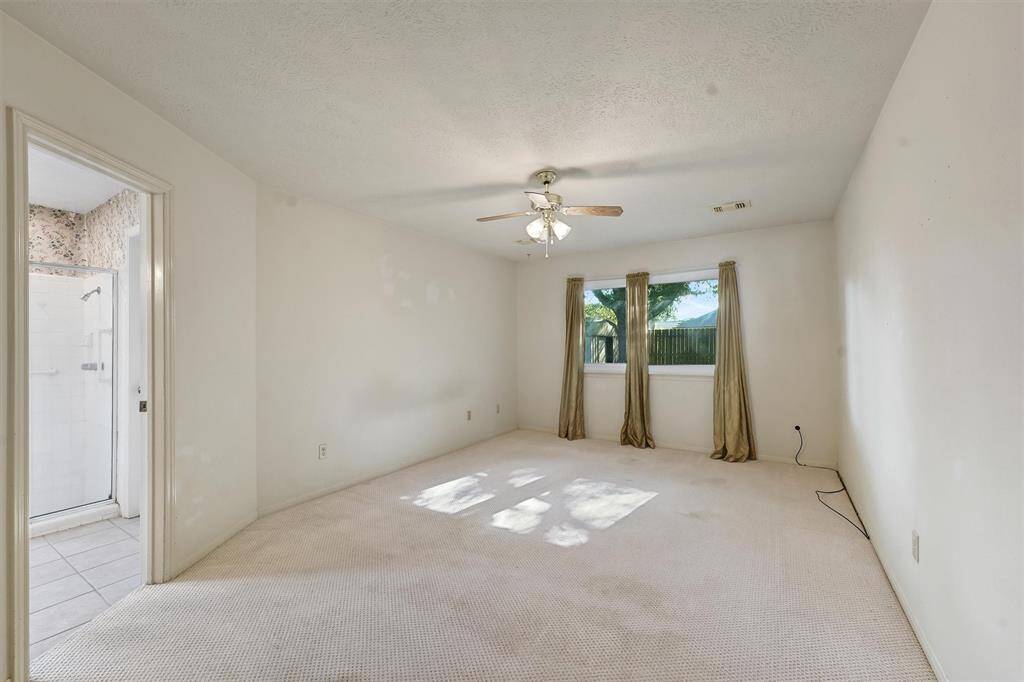 Bright, spacious primary bedroom features an ensuite bathroom.
