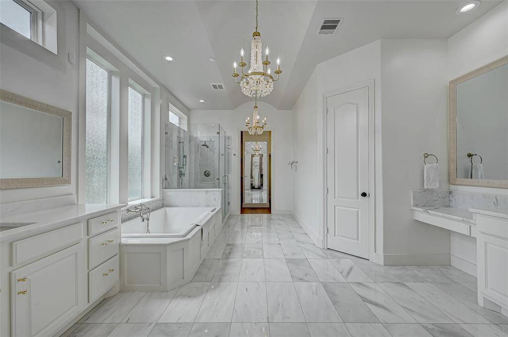 Primary Bath with his and her vanities.  Separate shower and bath.